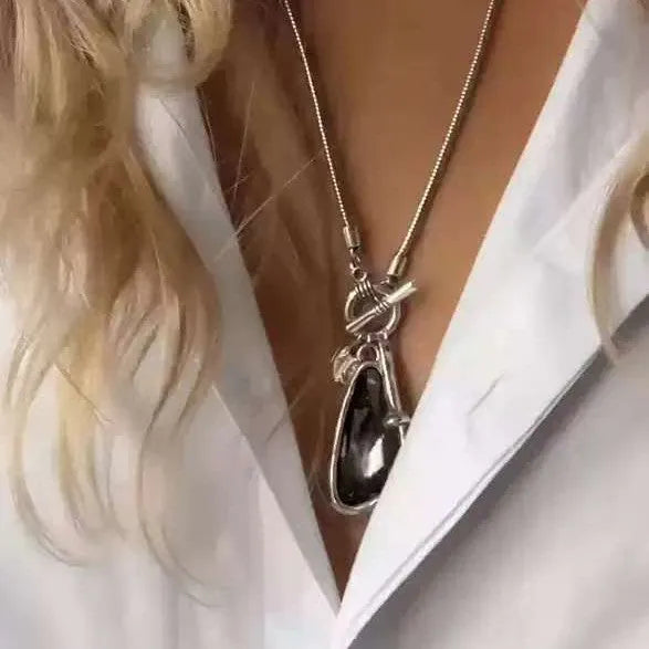 Women's geometric alloy pendant on a long snake bone chain necklace in blue, champagne, or grey.