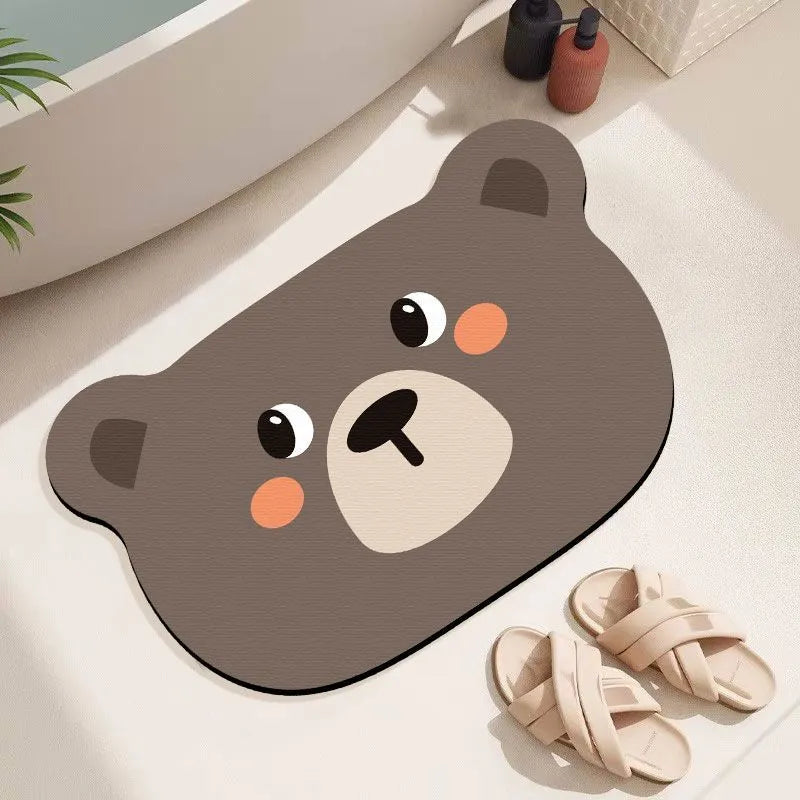 Alien-shaped diatomaceous earth bathroom mat with a cartoon hippo design on a tiled floor.