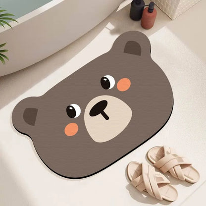 Alien-shaped diatomaceous earth bathroom mat with a cartoon hippo design on a tiled floor.