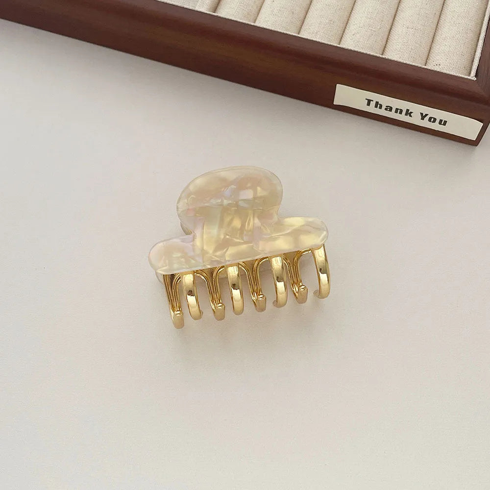 Acetate hair barrettes with metal alloy grip in leopard print, white, and ink colour options