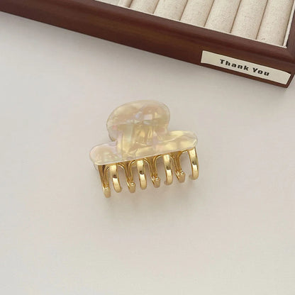 Acetate hair barrettes with metal alloy grip in leopard print, white, and ink colour options