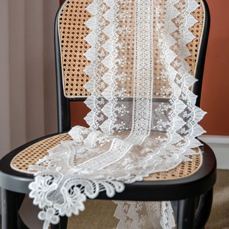 Elegant lace table runner with intricate embroidered patterns and hollowed-out design