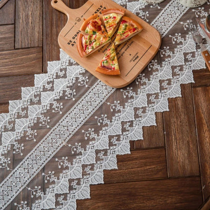 Elegant lace table runner with intricate embroidered patterns and hollowed-out design