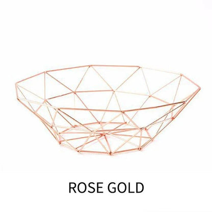 Wrought iron storage basket in black, gold, and rose gold colors, featuring a round, industrial-inspired design for versatile home organisation.