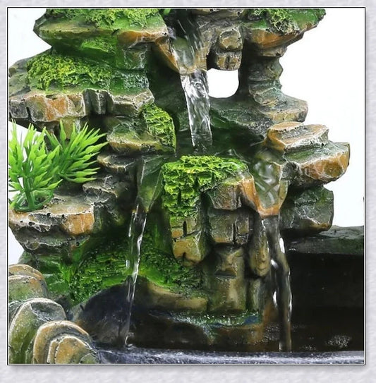 A beautiful resin tabletop fountain with flowing water, mimicking a river down a mountainside.
