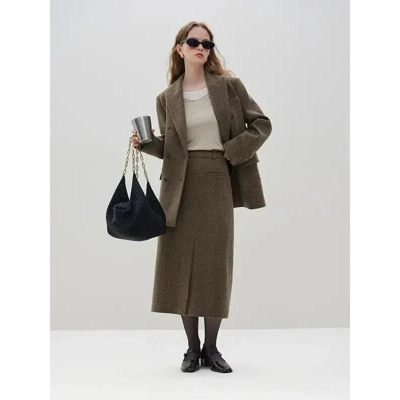 Elegant wool blazer skirt set for professional and formal wear, featuring a double-breasted jacket and a front-split long skirt in a sophisticated solid pattern.