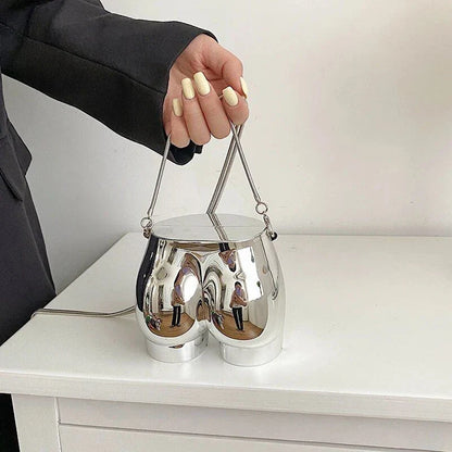A sleek and sophisticated acrylic crossbody bag in a striking silver colour, perfect for formal events and evening occasions.