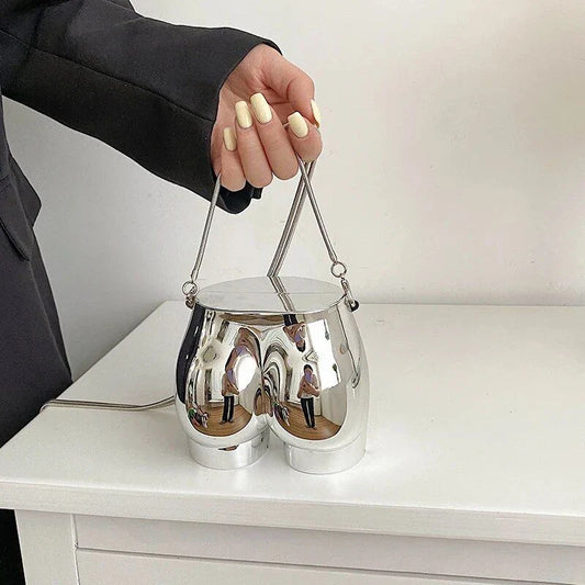 A sleek and sophisticated acrylic crossbody bag in a striking silver colour, perfect for formal events and evening occasions.