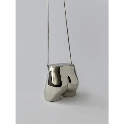 A sleek and sophisticated acrylic crossbody bag in a striking silver colour, perfect for formal events and evening occasions.