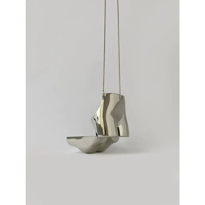 A sleek and sophisticated acrylic crossbody bag in a striking silver colour, perfect for formal events and evening occasions.