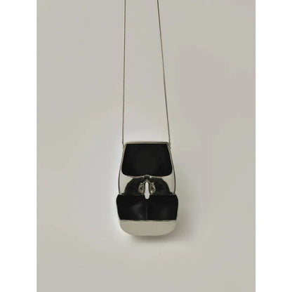 A sleek and sophisticated acrylic crossbody bag in a striking silver colour, perfect for formal events and evening occasions.