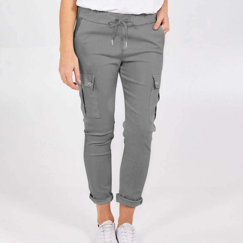 Women wearing casual cargo trousers with pockets in a solid colour and drawstring waist
