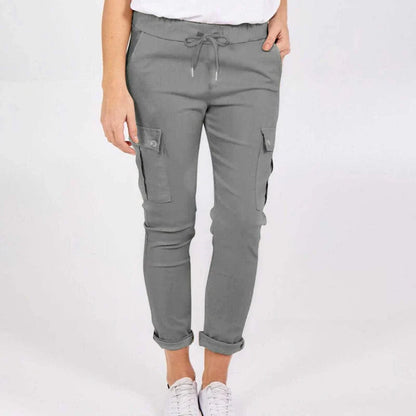 Women wearing casual cargo trousers with pockets in a solid colour and drawstring waist