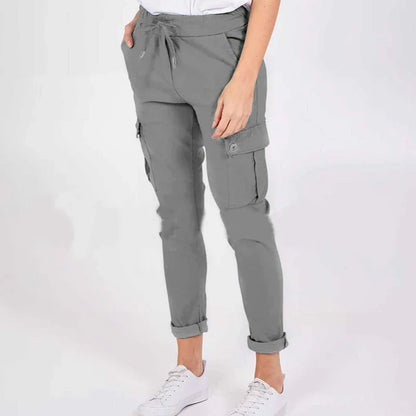 Women wearing casual cargo trousers with pockets in a solid colour and drawstring waist