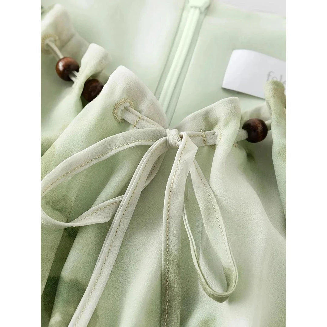 Elegant Chinese-inspired dress with a romantic, sophisticated design in creamy-white colour
