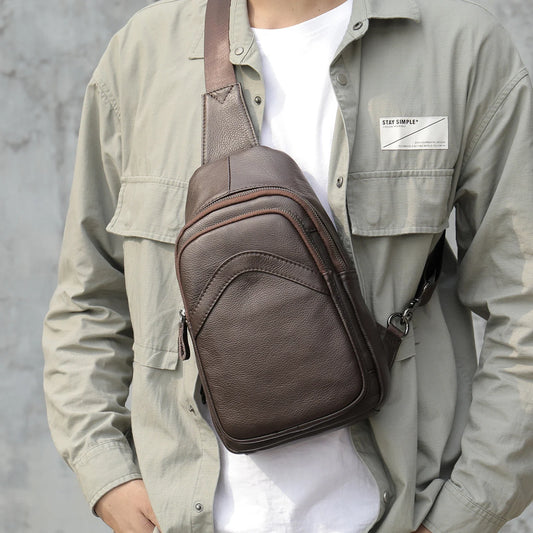 Premium genuine leather crossbody bag in black with multiple internal compartments and adjustable strap for versatile everyday wear