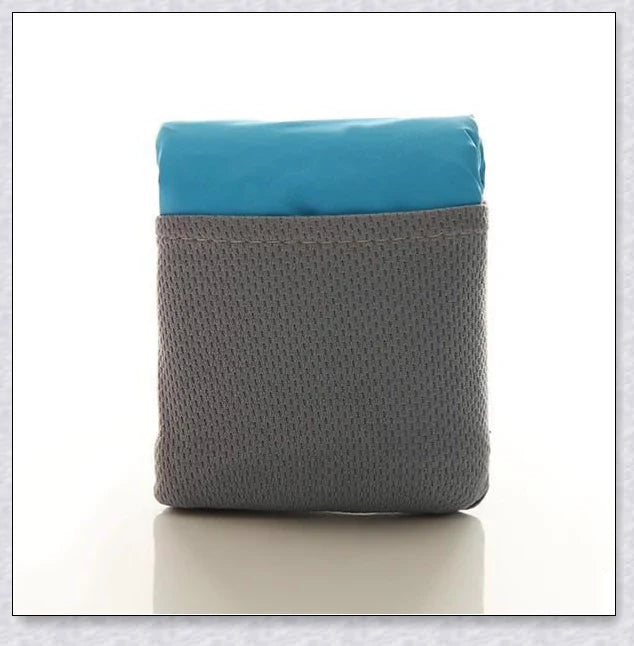 Premium pocket blanket with water-repellent and puncture-resistant design, perfect for outdoor adventures and picnics