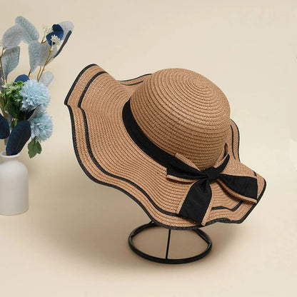 A stylish bowknot straw sun hat providing excellent UV protection and comfort for summer adventures