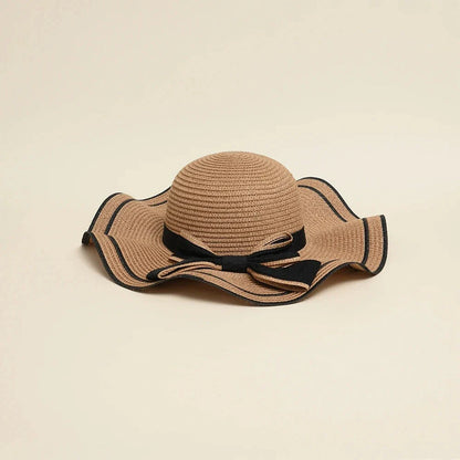A stylish bowknot straw sun hat providing excellent UV protection and comfort for summer adventures