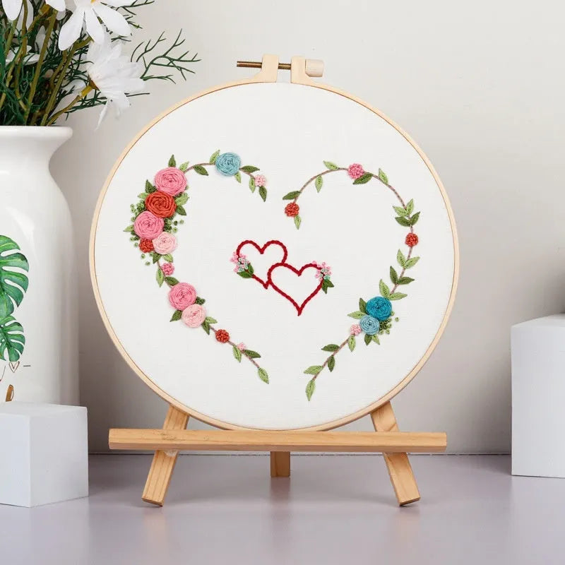 DIY Valentine's heart embroidery kit with cotton cloth and 20cm bamboo ring on a table.