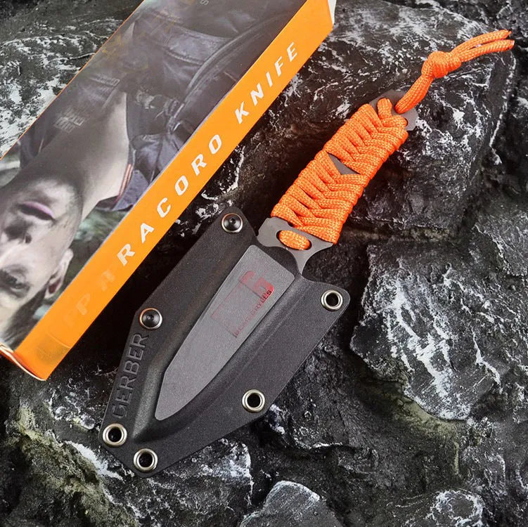 Straight-blade survival knife with a binding rope handle next to its black ABS plastic sheath.