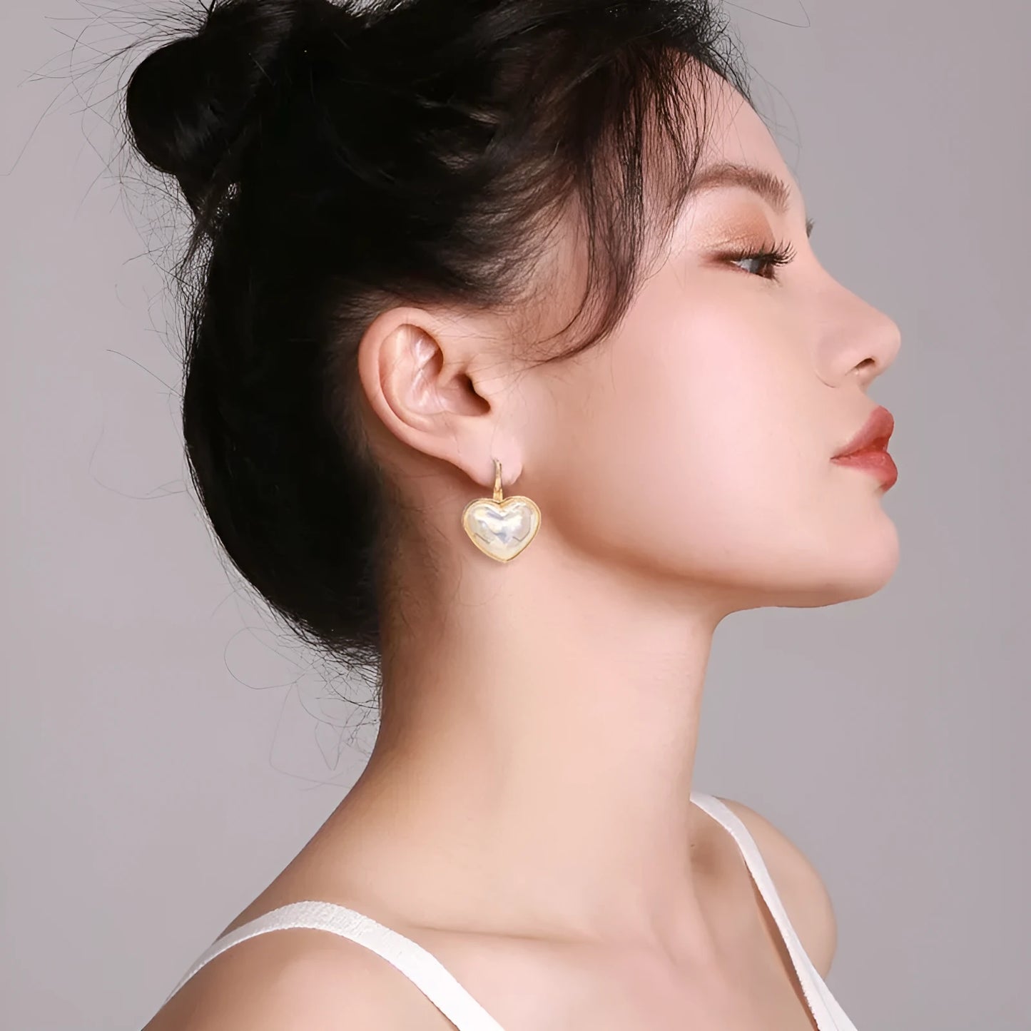 Gold-coloured alloy clip-on earring for women with a natural design.