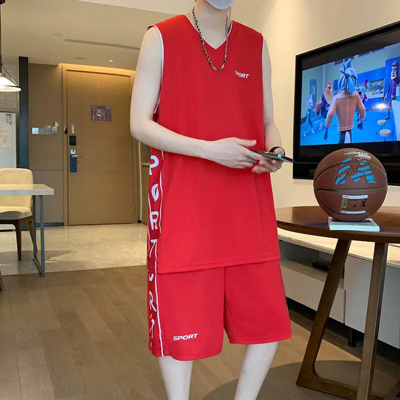 Man wearing a grey sleeveless basketball vest and matching shorts for sports.