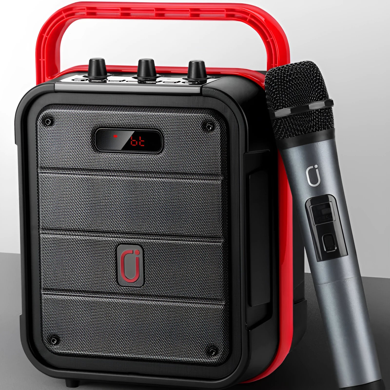 MS62AI portable Bluetooth speaker with wireless microphone on a table, showing control knobs and strap.