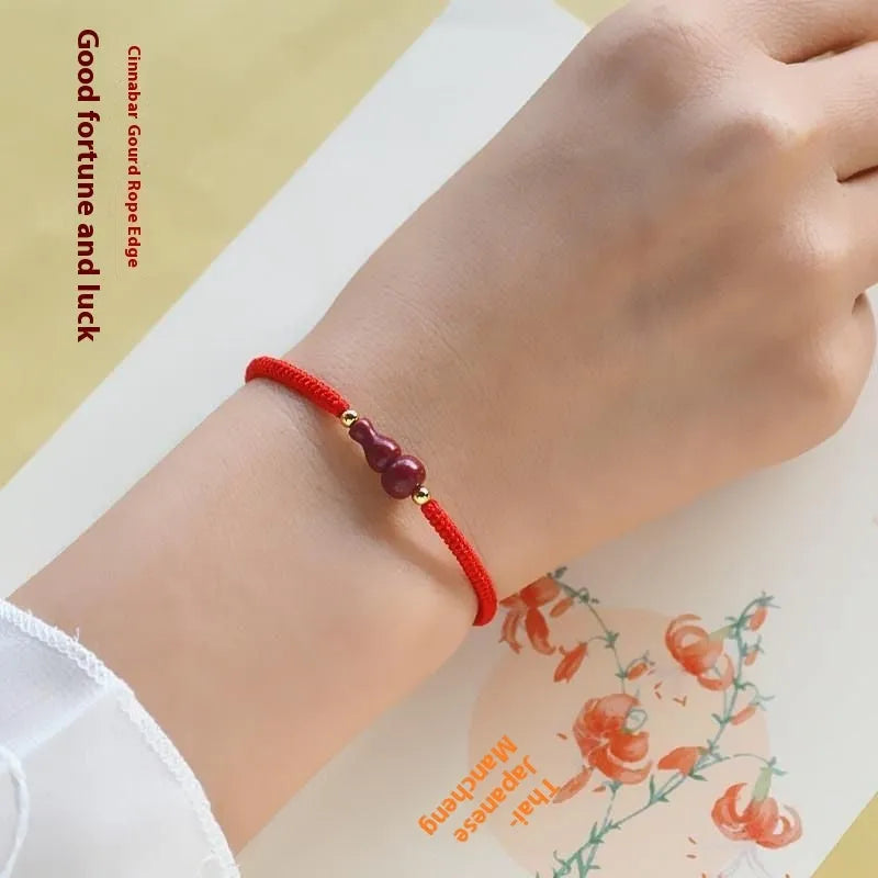 Cinnabar heart-shaped bracelet with safety buckle closure and adjustable coloured rope in traditional Chinese design