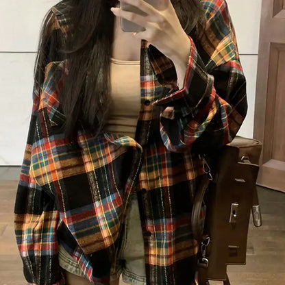 Woman wearing a loose-fit black and white plaid long sleeve shirt made from 100% cotton.