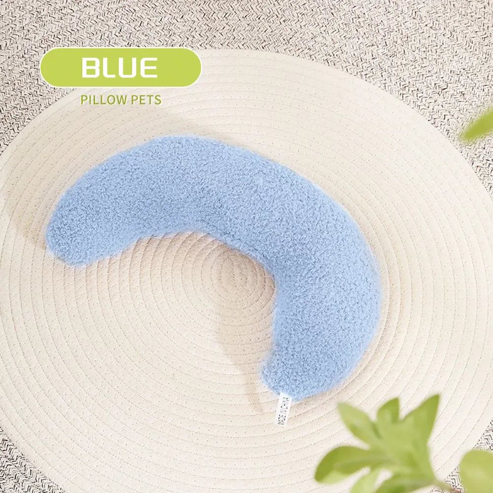 U-shaped blue cat pillow with adjustable neck collar on a sofa