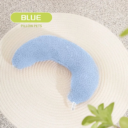 U-shaped blue cat pillow with adjustable neck collar on a sofa