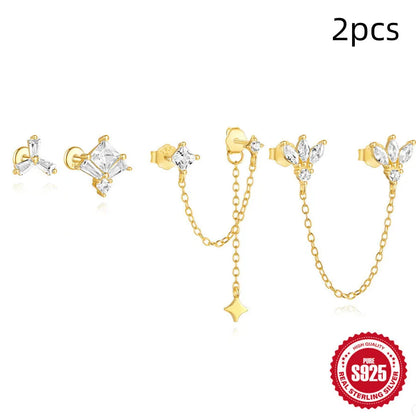 Close-up of golden-toned sterling silver double stud earrings with a delicate chain and sparkling zircon stone.