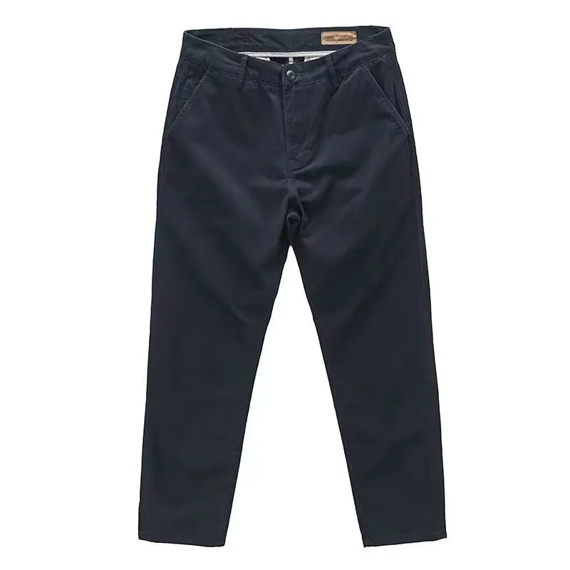 Man wearing slim fit grey micro elastic washed trousers with a straight leg cut for a business casual look.