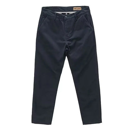 Man wearing slim fit grey micro elastic washed trousers with a straight leg cut for a business casual look.