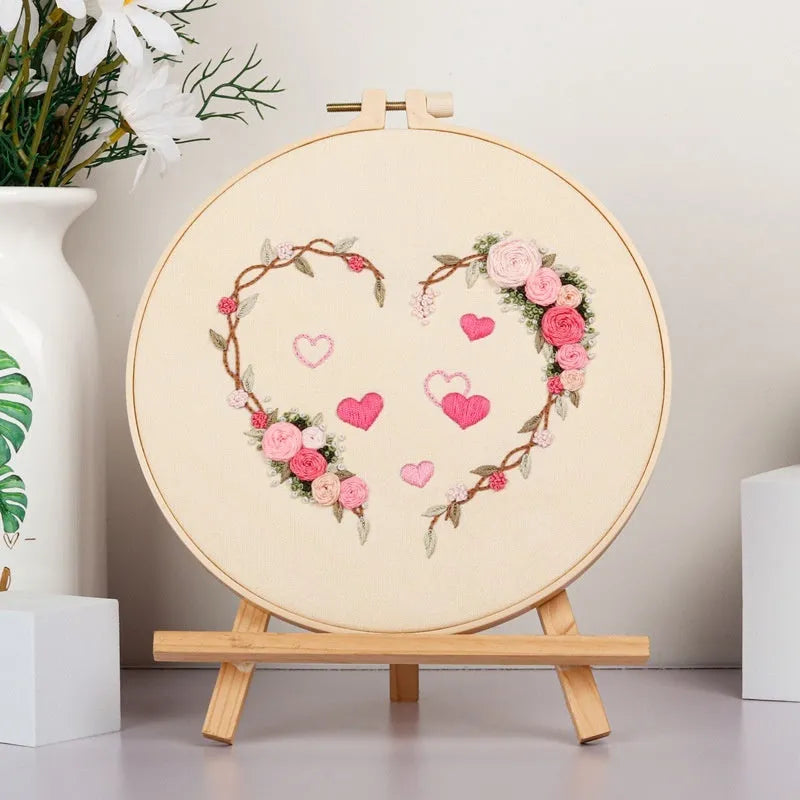 DIY Valentine's heart embroidery kit with cotton cloth and 20cm bamboo ring on a table.