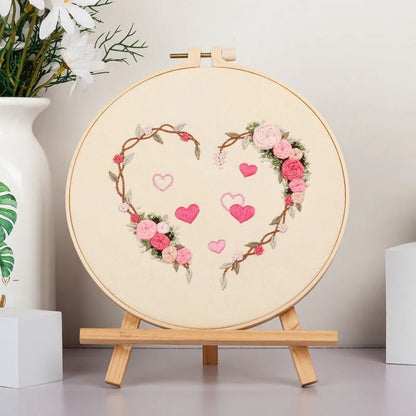 DIY Valentine's heart embroidery kit with cotton cloth and 20cm bamboo ring on a table.