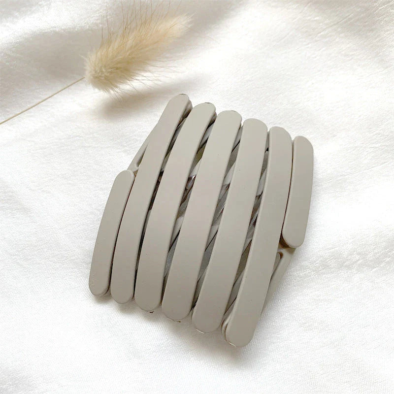 Compact retractable hair band with non-slip teeth grip, available in various colors for versatile styling