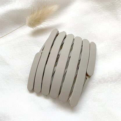 Compact retractable hair band with non-slip teeth grip, available in various colors for versatile styling