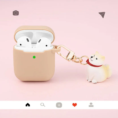 Silicone AirPods case with Shiba Inu pendant in yellow, white, or black, universal fit for AirPods 1 and 2.