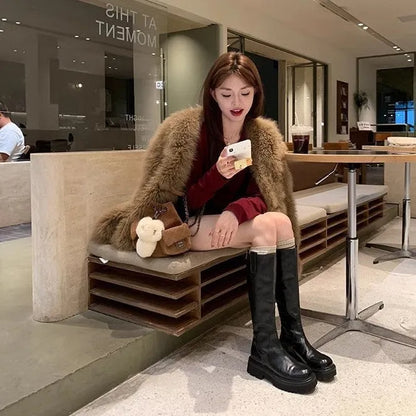 Round toe black chunky heel women's knight boots with a back zipper on a rubber sole.