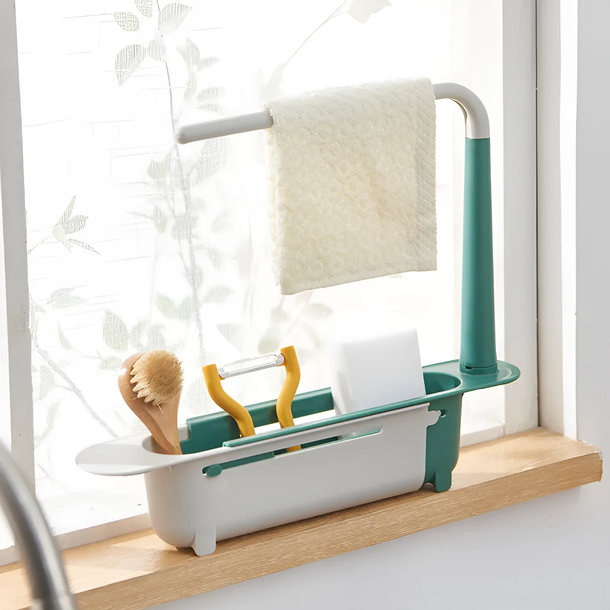 Telescopic plastic kitchen sink drain rack with multi-coloured modular baskets.