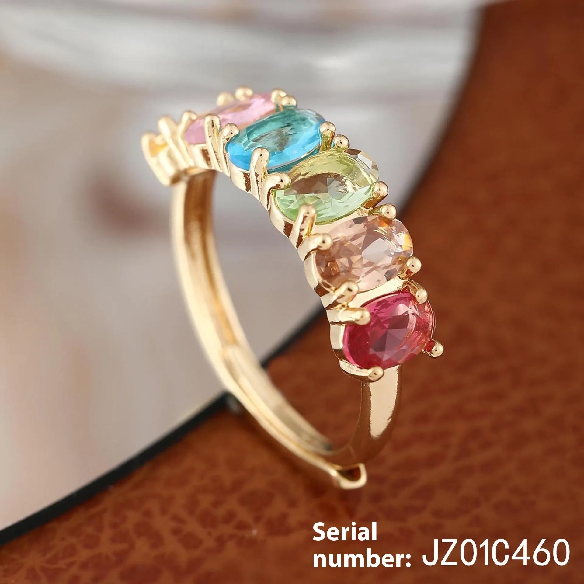 Adjustable gold-colour copper ring with zircon detail on woman's finger