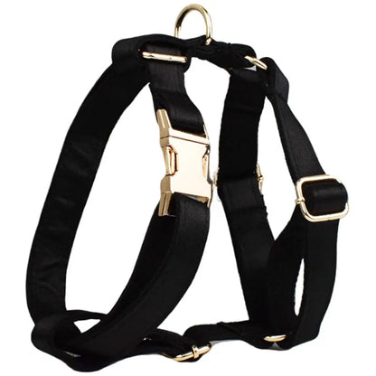 Cloth dog collar and leash set with chest strap harness, adjustable vest, and decorative bow.
