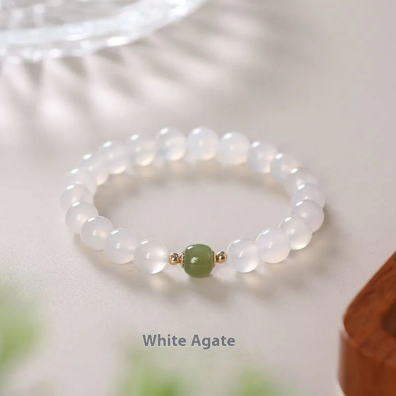 Handmade white agate and crystal bracelet with cinnabar inlay, showing 6mm or 8mm bead options.