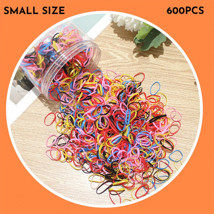 Assorted colourful thin TPU baby hair ties for toddlers and kids in a reusable plastic storage container.