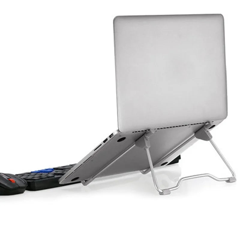 Grey aluminium and plastic adjustable stand holding a mobile phone on a wooden desk.
