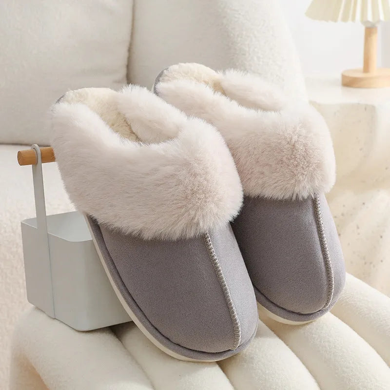 Women's plush winter slippers with round toe, flat heel, and stitching detail on a non-slip PVC sole.