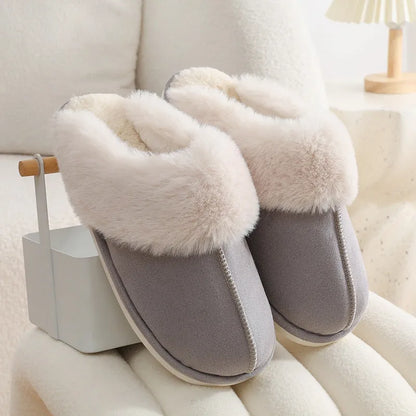 Women's plush winter slippers with round toe, flat heel, and stitching detail on a non-slip PVC sole.