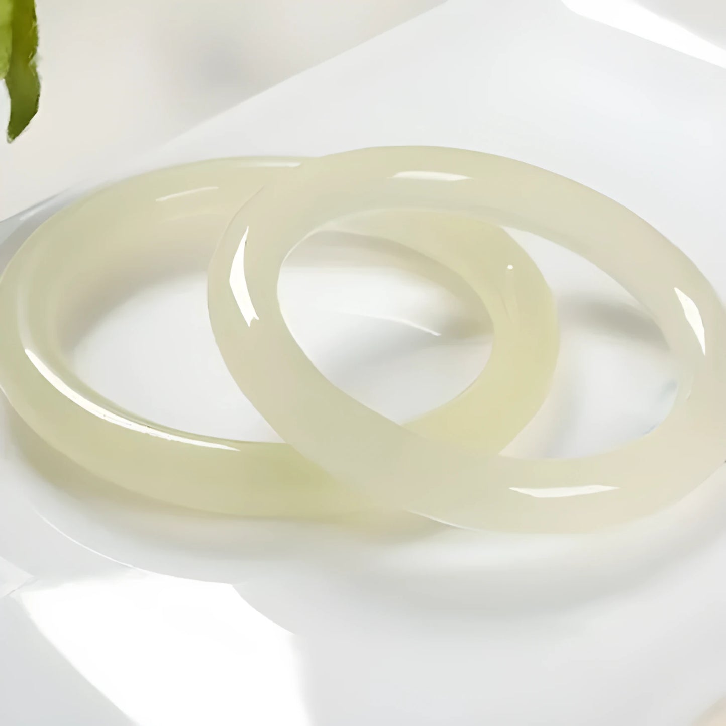 Ice silk jade round bar bracelet shown on a wrist, highlighting its smooth cylindrical shape and natural stone material.